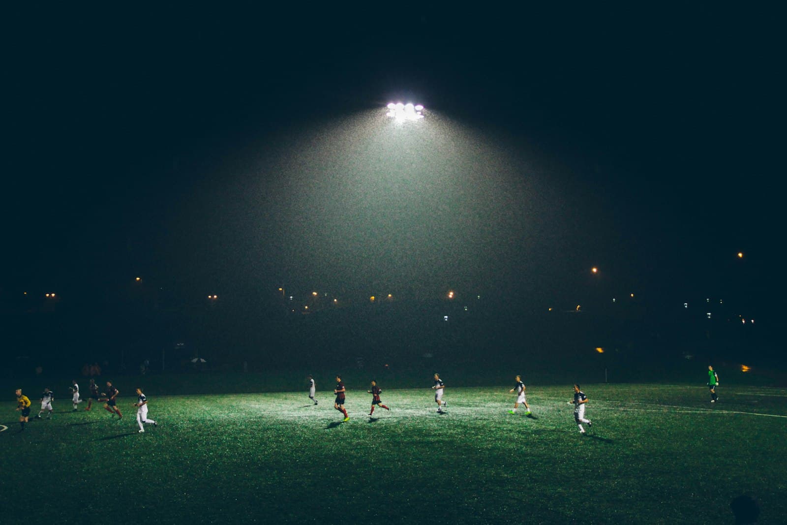 Soccer ball beside a player's foot on grass
