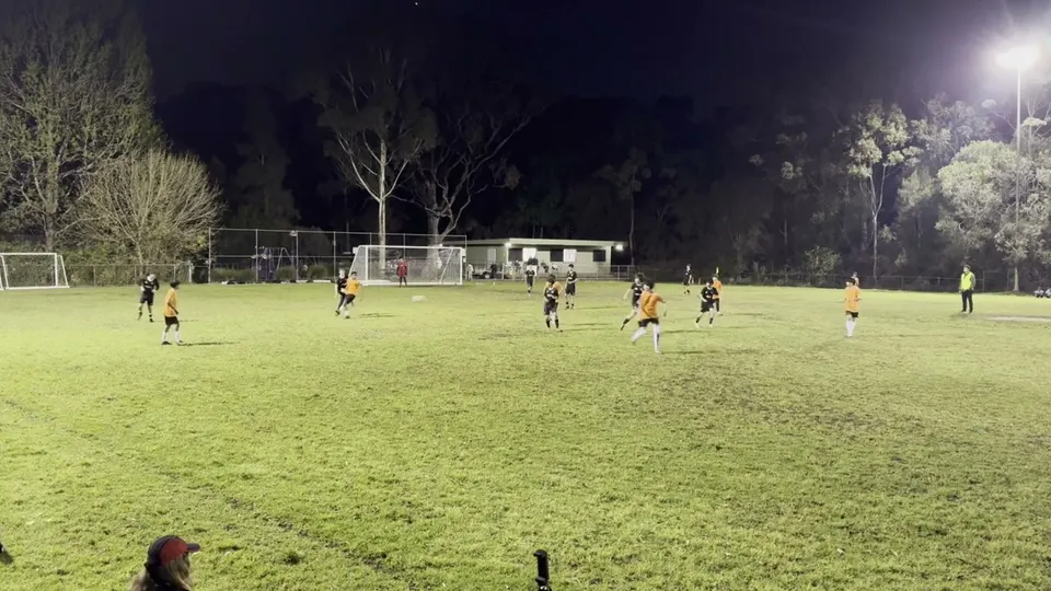 Soccer passing and a change of direction under floodlights
